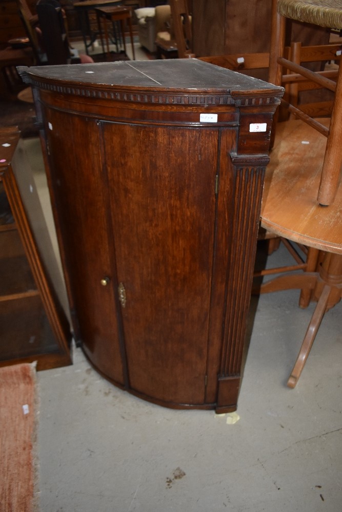 A Georgian corner cabinet having internal shelves,key included.