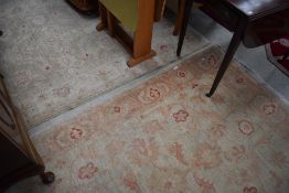 Two vintage rugs, faded cream and red pattern, approx. 216 x 133cm and 210 x 150cm