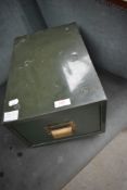 A vintage index card filing drawer in a military style