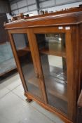 A late 19th/early 20th Century oak bookcase having large ball and claw feet, width approx. 108cm