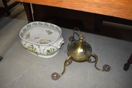 A reproduction footbath and brass ceiling light fitting