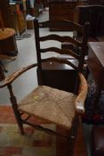 A late 18th/early 19th century rush seated ladder back chair, two rungs removed from lower portion.