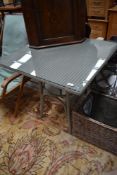 A Lloyd Loom square table having glass top, approx 76 x 76cm