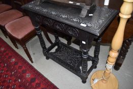 A Victorian shallow side table having carved decoration