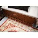 A traditional bedding box, pine with overstuffed top , width approx. 122cm Bearing label for