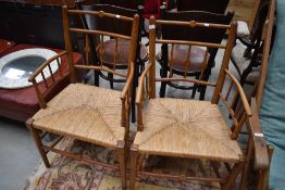 A pair of Victorian rush seated spindle frame chairs in the Arts and Crafts design
