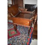 A 19th Century mahogany servery table having lift flap with inner tray on turned legs and pot