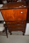 An early 20th Century mahogany/walnut cocktail or side cabinet, having flap top and three drawer