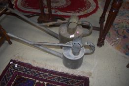 Two vintage metal watering cans