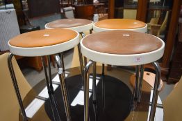 A set of four vintage stools having formica tops and chromed legs