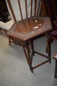 An early 20th Century oak occasional table having carved top and turned legs