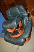 A green leather stressless armchair and footstool