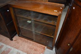 An early 20th century bookcase having glass doors and shelves.