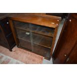 An early 20th century bookcase having glass doors and shelves.