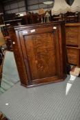 A 19th Century oak corner cupboard of small proportions, height approx. 61cm