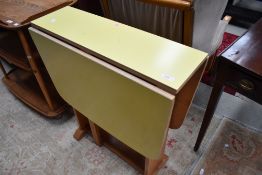 A vintage formica top drop leaf kitchen table