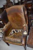 A vintage leather wing armchair