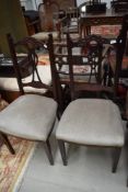 A pair of early 20th Century dining chairs having later dralon upholstery