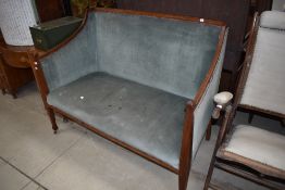 An Edwardian mahogany settee having blue dralon upholstery