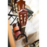 Three acoustic guitars and a guitar stand