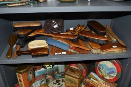 A large collection of wooden dress and crumb brushes also a pack of bakelite carpet grips