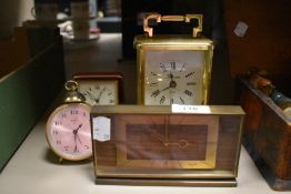 A group of four clocks including mid century Swiza and brass cased carriage clock by Time master