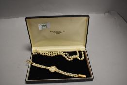 A cultured pearl necklace of even knotted form having a silver clasp, approx 18' and a fashion dress