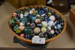 A selection of 20th century glass and similar marbles and games tokens