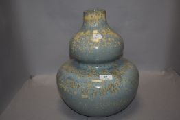 A modern Chinese style double gourd vase with a mottled blue and cream glaze