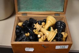 A selection of wooden tournament style chess pieces having weighted bases