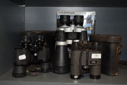 Three pairs of binoculars including Omiya 8x40, Swift 8x30 and Traveler 30x60