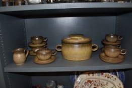 A set of six tea cups by Denby with milk jug and lidded crock pot