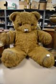 An early 20th century large plush teddy bear having large eyes