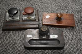 Two mid Victorian desk top ink well pen holders and a similar aged blotter