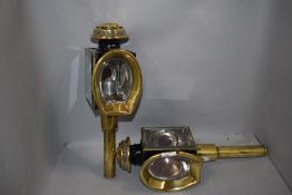 A pair of antique carriage lamps having brass fixtures and cut bevelled glass having come from the