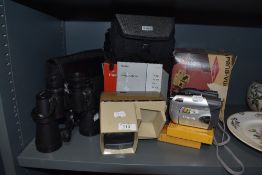 A selection of photographic equipment including Swift 10x50 binoculars and Canon DVD camcorder