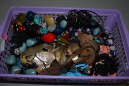 A small selection of costume jewellery necklaces including shell disc, polished stone etc