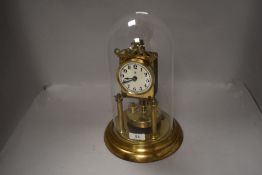 A 20th century glass domed anniversary clock German made bearing crescent moon and B mark