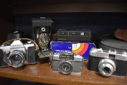 A selection of cameras and photographic equipment including Olympus, Praktica and Mastra