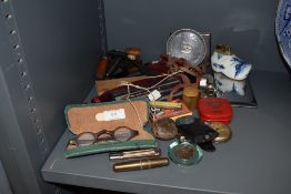 A selection of curios and trinkets including whistles, cigarette lighters and pocket knives