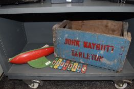 A vintage wooden crate marked for John Baybutt Tarleton, a toy yacht and a Disney xylophone.