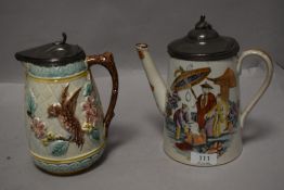 An antique French Majolica water jug having bird design with pewter lid and a similar late Victorian