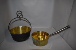 Two antique brass cast farm house pans including jam and sauce