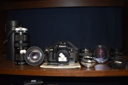 A selection of cameras and photographic equipment including Canon A-1 and Vivitar 75-205mm 1:3.8