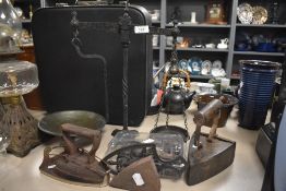 A selection of antique hardware including stove top irons and balance scale set