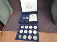 A collection of Silver Proof Motorsport Coins from Isle of Man and Liberia in coin box