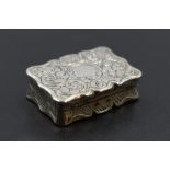 A small Victorian silver vinaigrette of shaped form having pierced gilt grill and interior, engraved