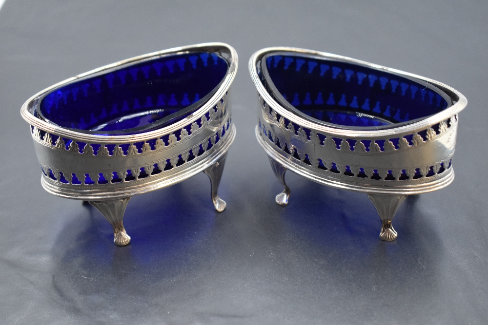 A pair of George III silver salts, of elliptical form with pierced decoration and Bristol blue glass