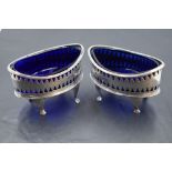 A pair of George III silver salts, of elliptical form with pierced decoration and Bristol blue glass