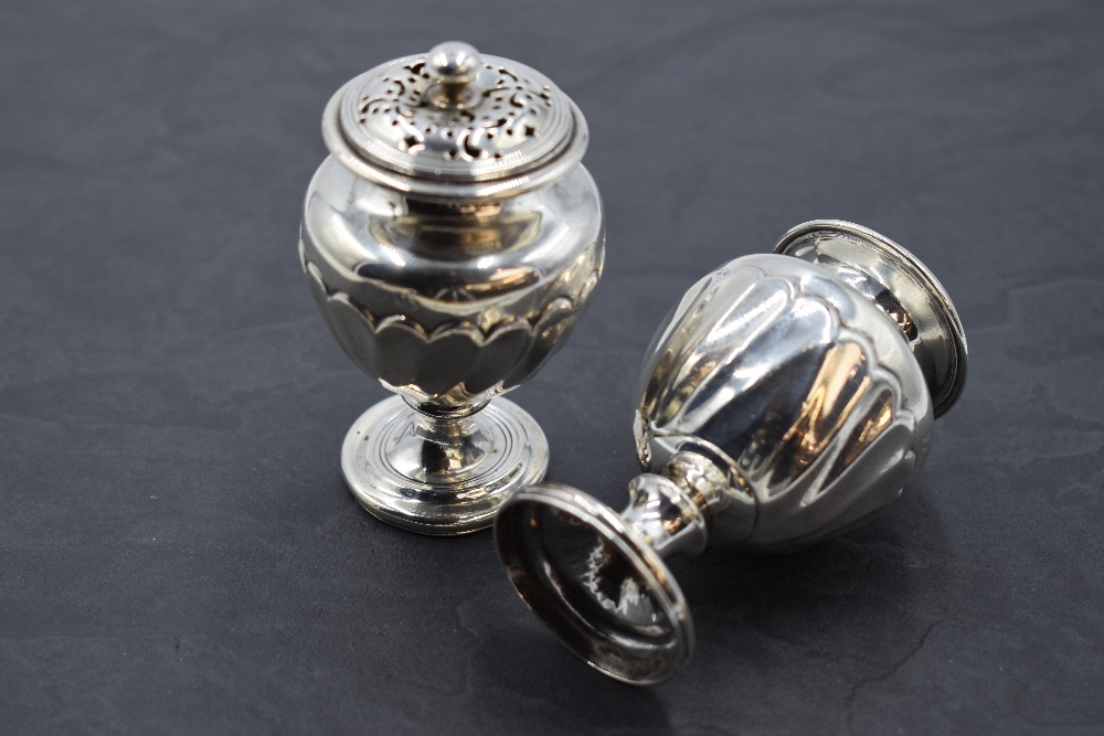 A pair of 19th century silver pepperettes, of urn-form with pierced finial topped pull-off covers - Image 2 of 2